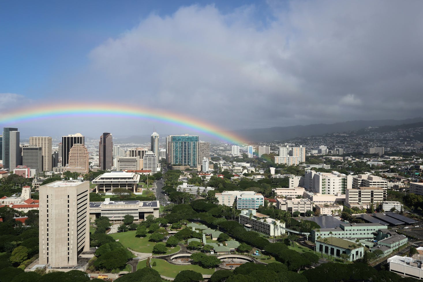 A rainbow over the hotels and shopping malls of Honolulu