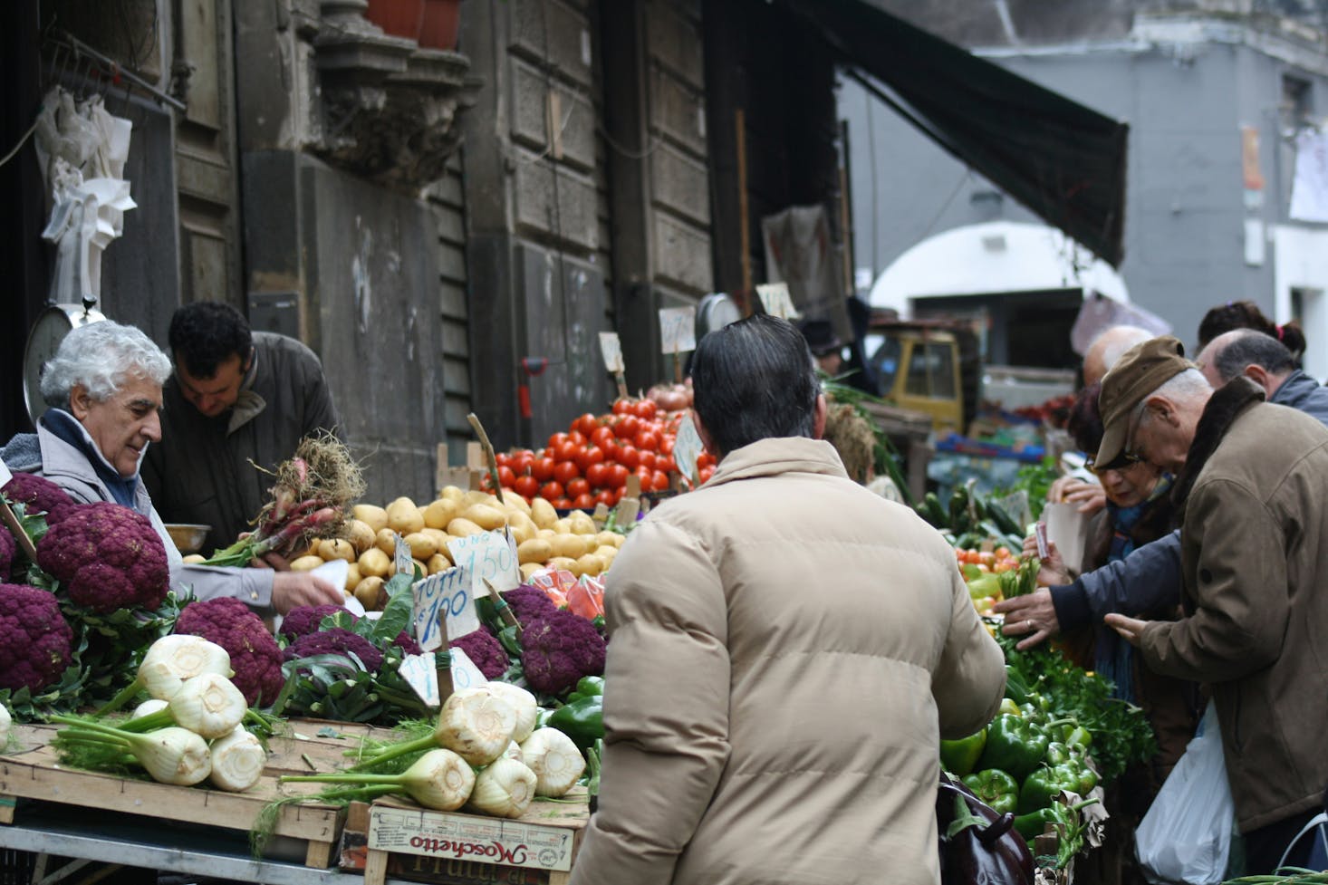 People shopping for produce on the street in Catania