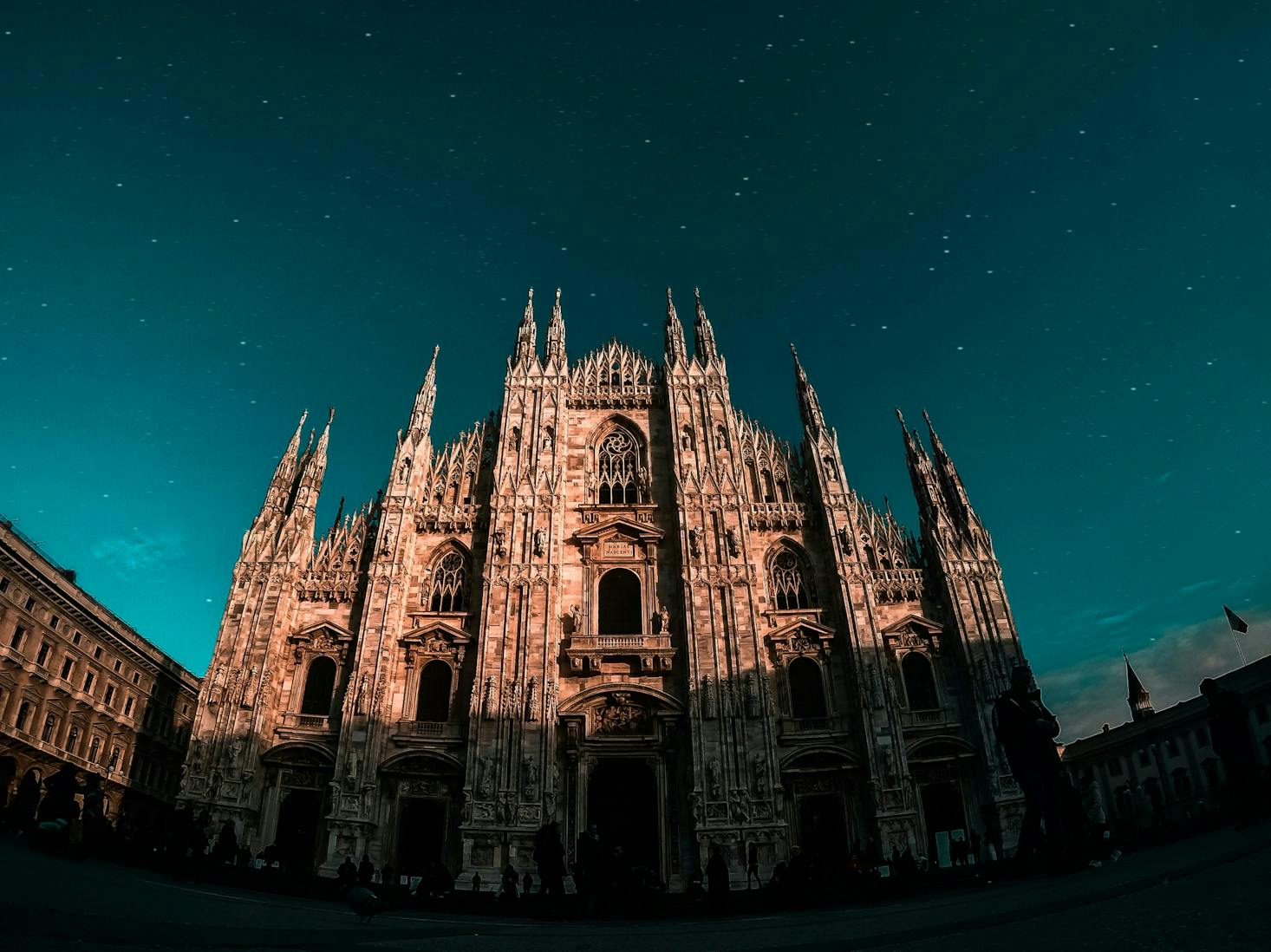 Low angle view of the Duomo Cathedral in Milan under a starry night sky