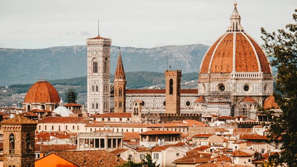 Florence Cathedral (Cattedrale di Santa Maria del Fiore) with its red-tiled dome, marble facade, and surrounding architecture