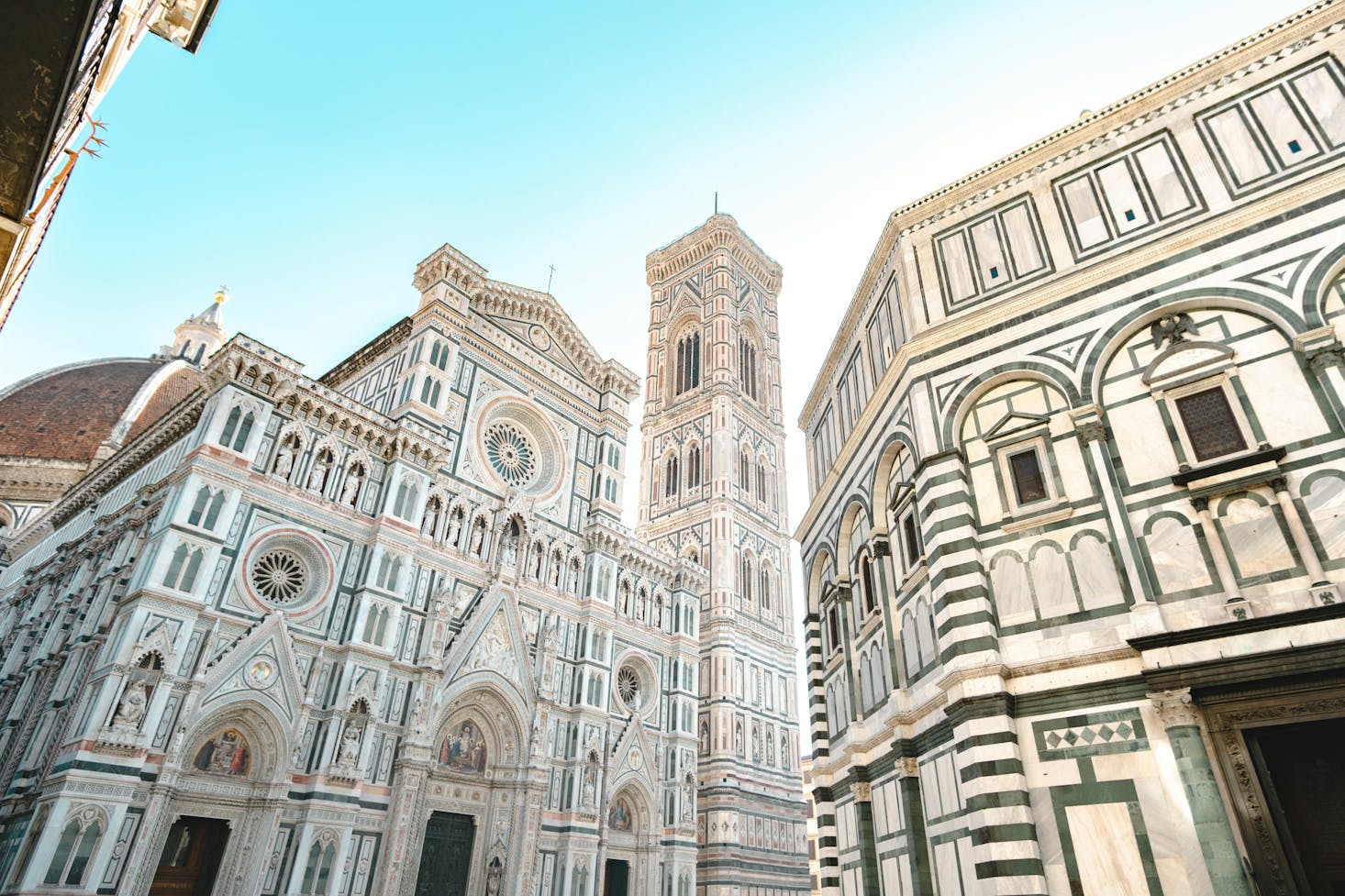 Low angle view of the Cathedral of Santa Maria del Fiore under a blue sky