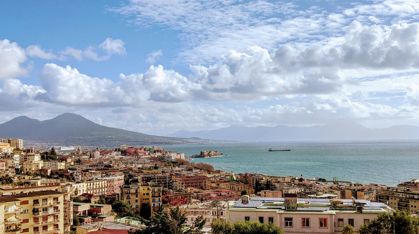 Colorful architecture in Naples next to the sea and mountain