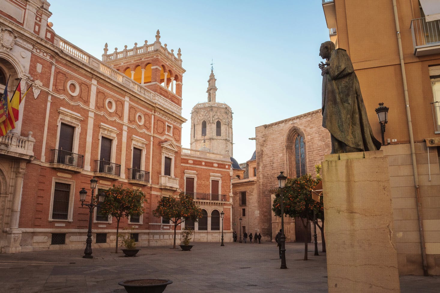 A statue surrounded by ornate city buildings in Valencia city