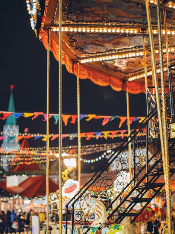 Illuminated carousel at an amusement park at night