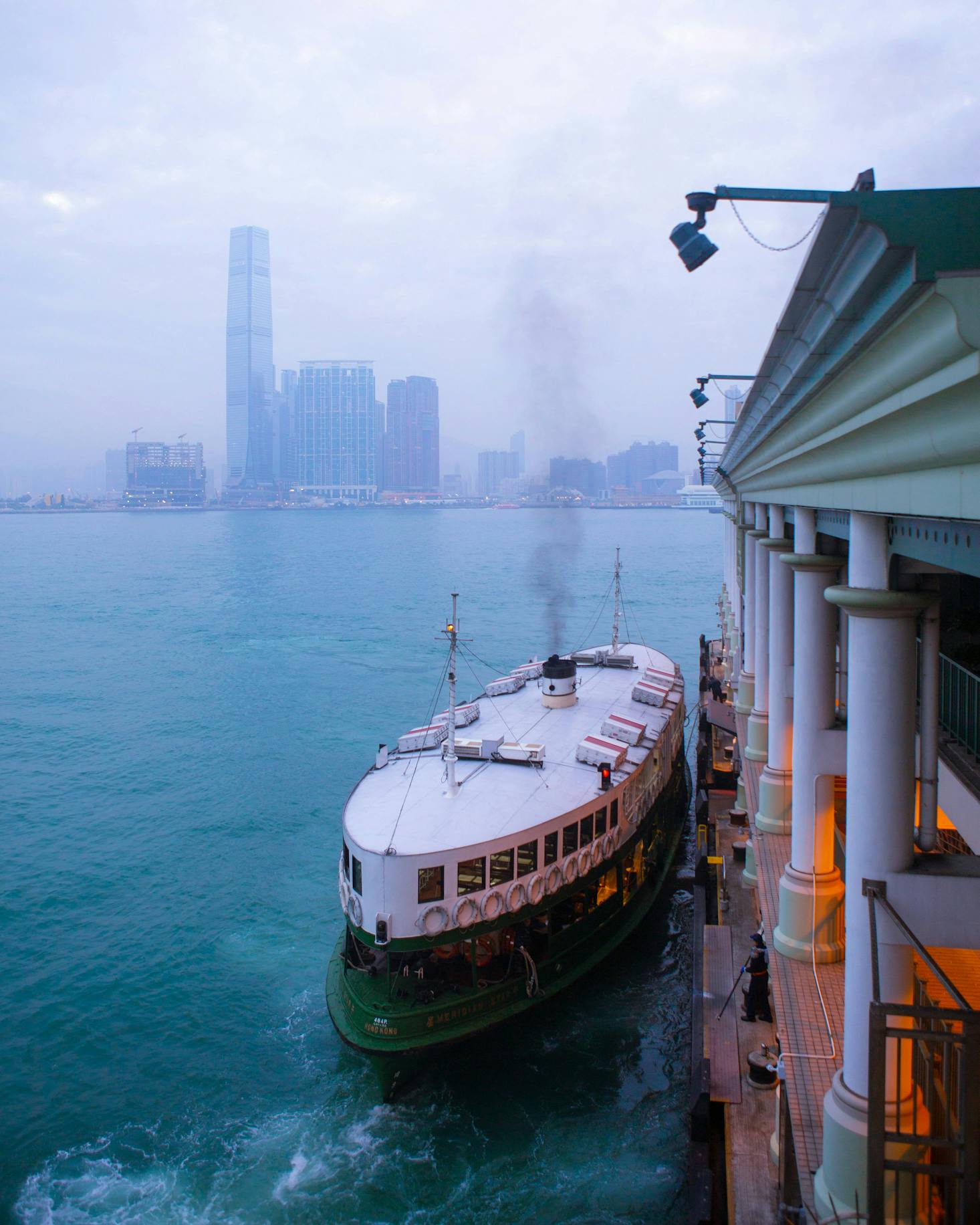 Ferry docked at the Hong Kong Macau Ferry Terminal, with city skyline in background