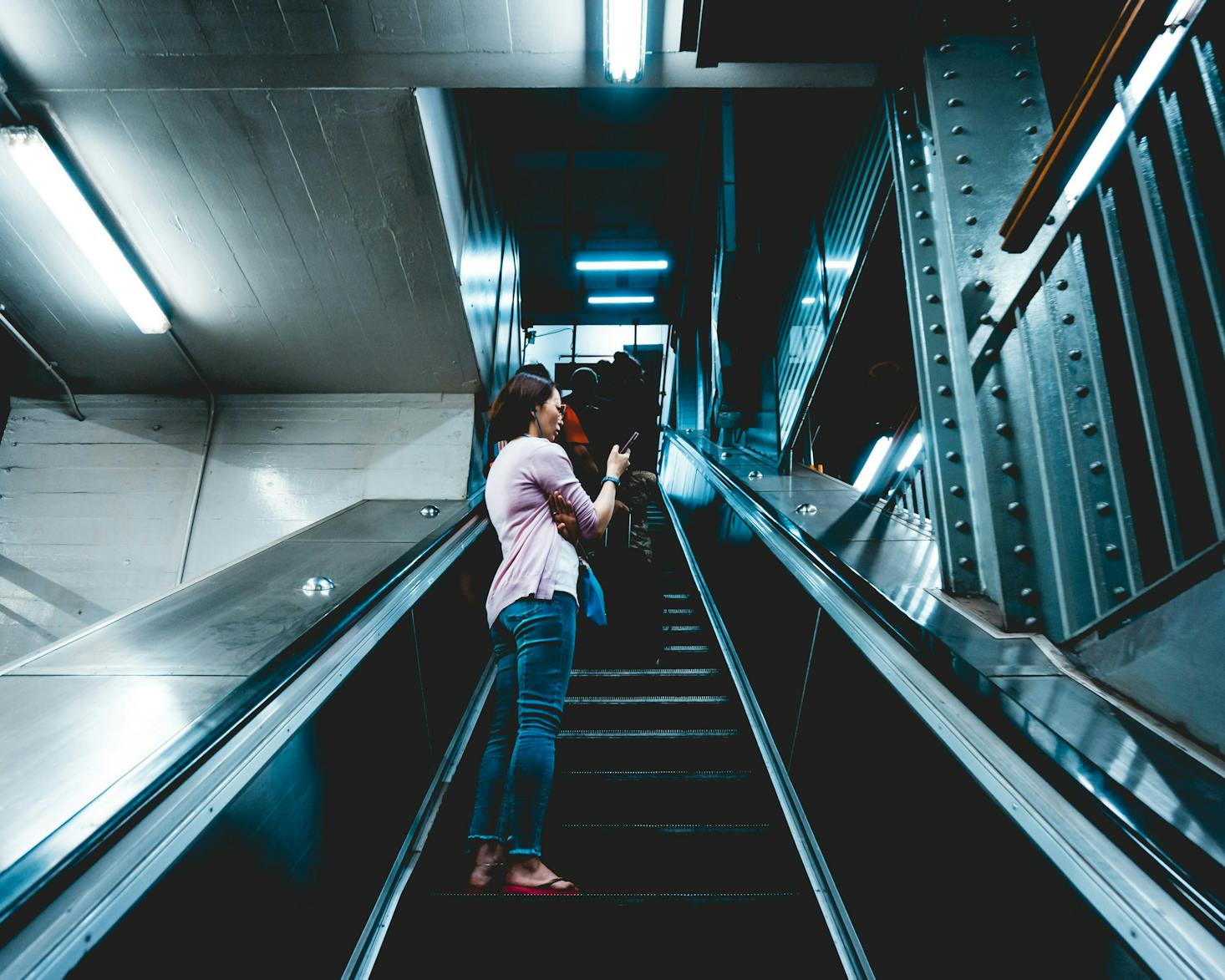 A person riding up the escalator at Sydney Town Hall Station