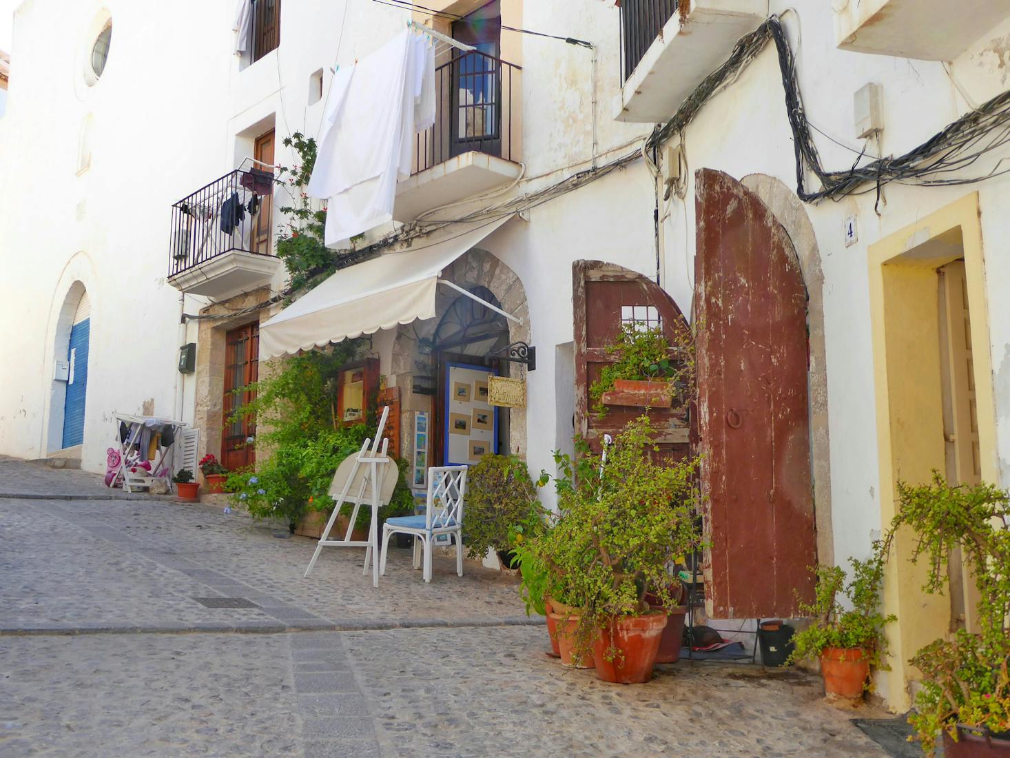 Hilly street in Ibiza Town showing the need for luggage storage