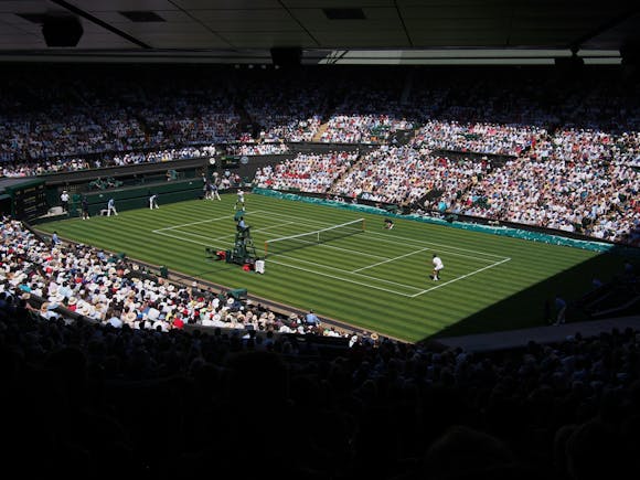 The Wimbledon centre court at the All England Lawn Tennis and Croquet Club during a heated tennis match