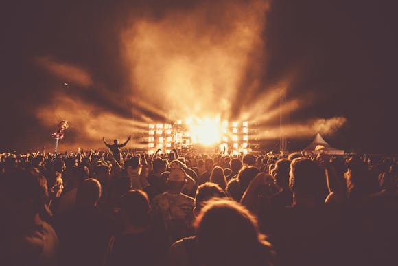 EDM festival performance at Donauinselfest Vienna, featuring a light show and smoke