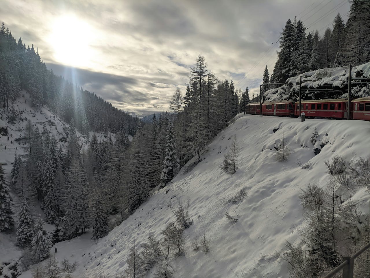 Bernina Express train traveling through the mountains in Tirano, Italy