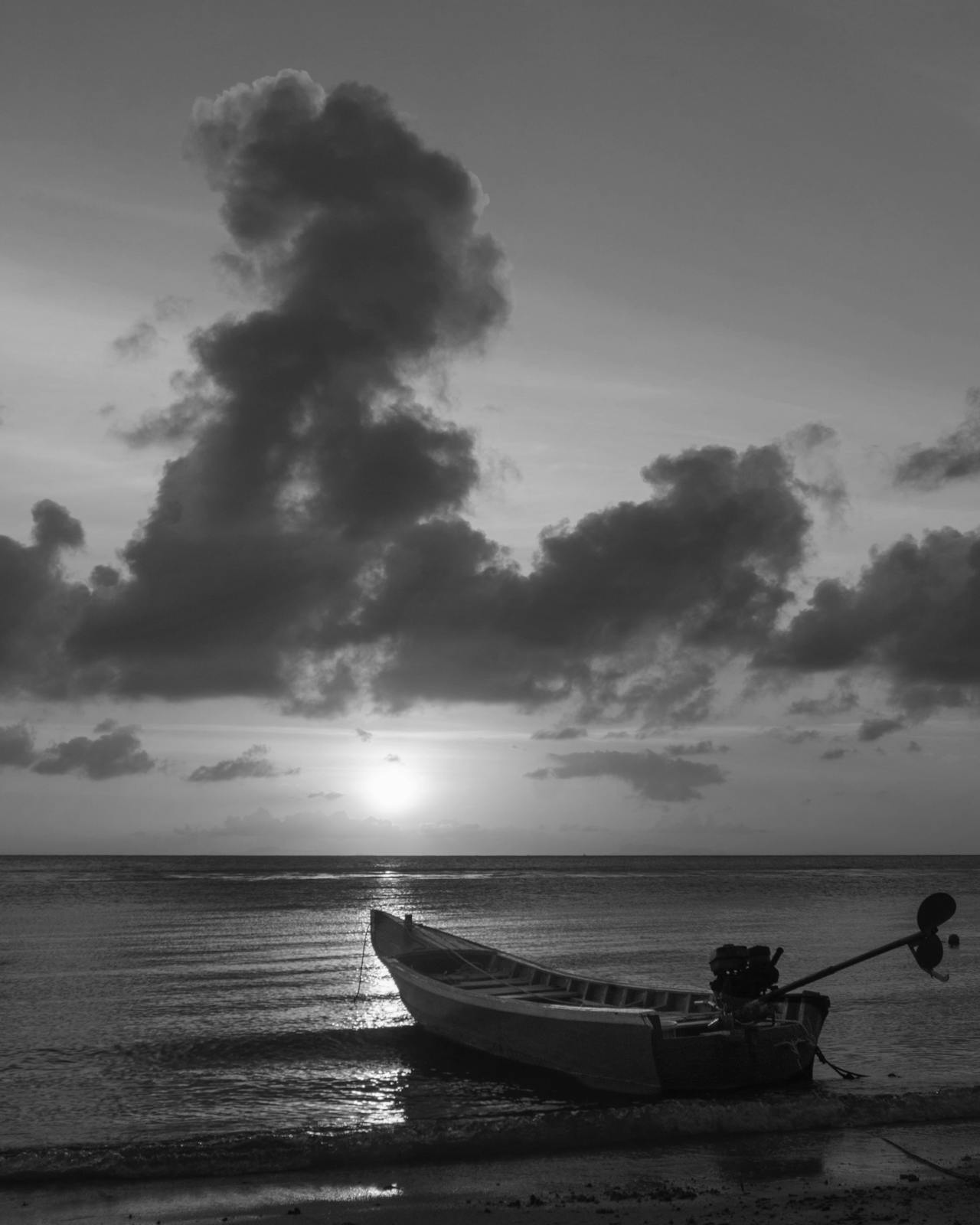 Boat in the water at sunset in Ko Pha Ngan, Thailand