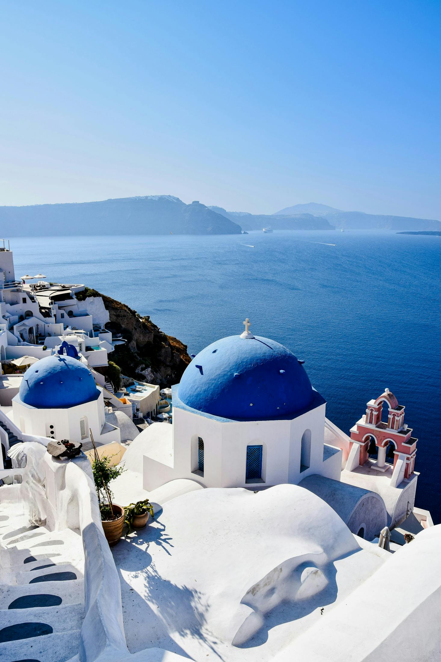 Breathtaking views of the iconic blue domes and whitewashed buildings of Santorini, Greece.