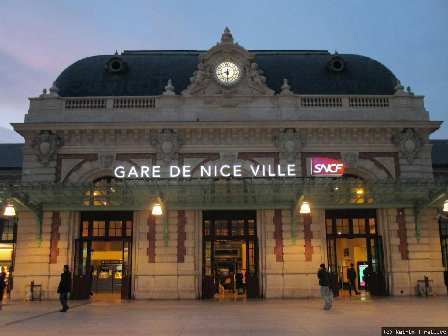 Gare de Nice Ville showcasing its elegant architecture and illuminated facade at dusk.