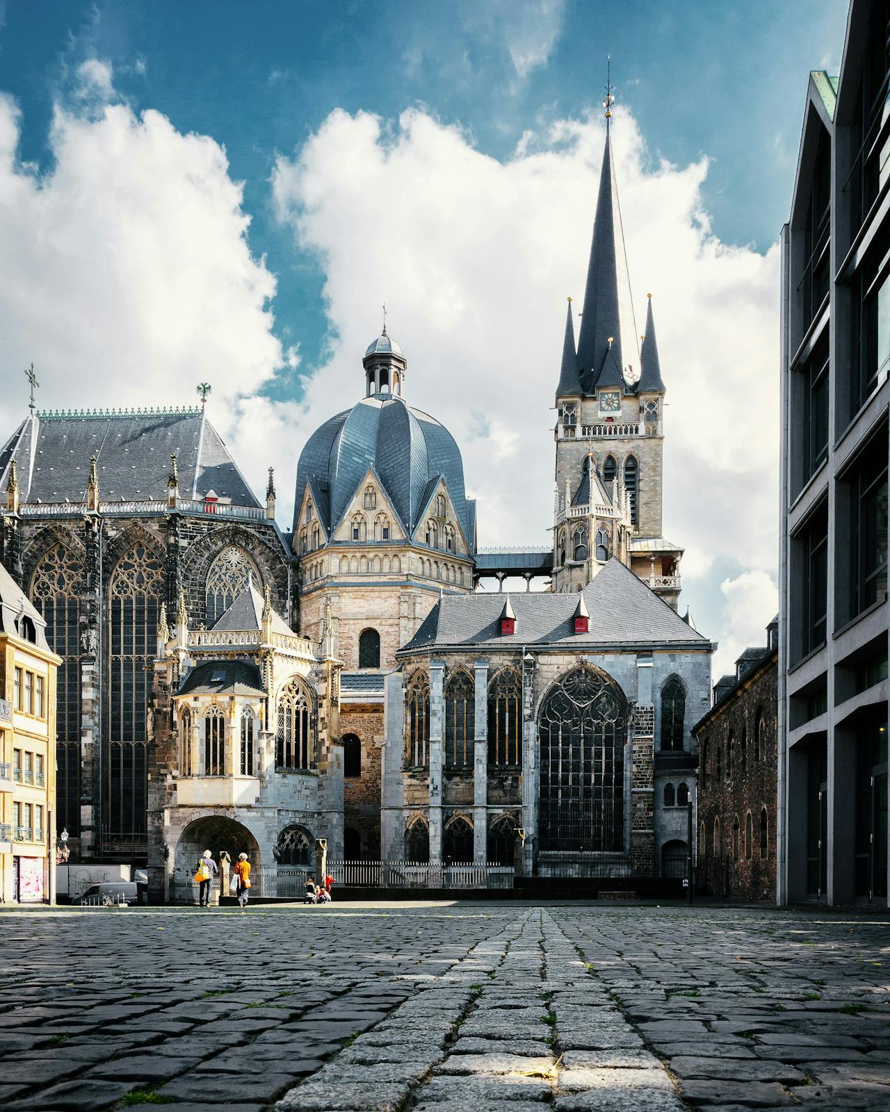 A stunning gothic cathedral with intricate details is towering majestically in Aachen.