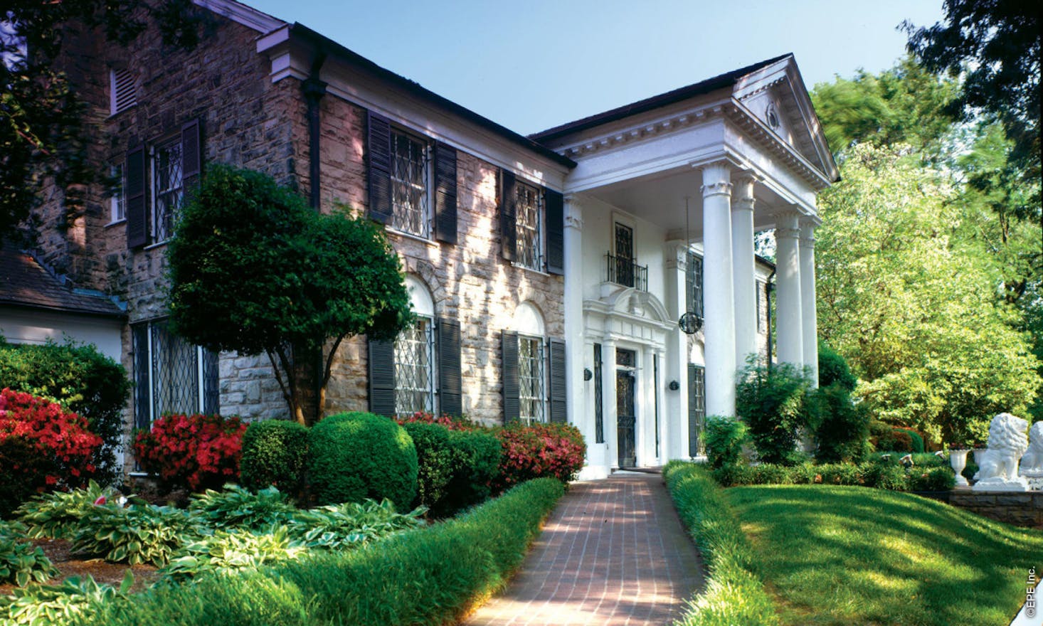 Front view of Graceland, a grand mansion with a stately white-columned entrance