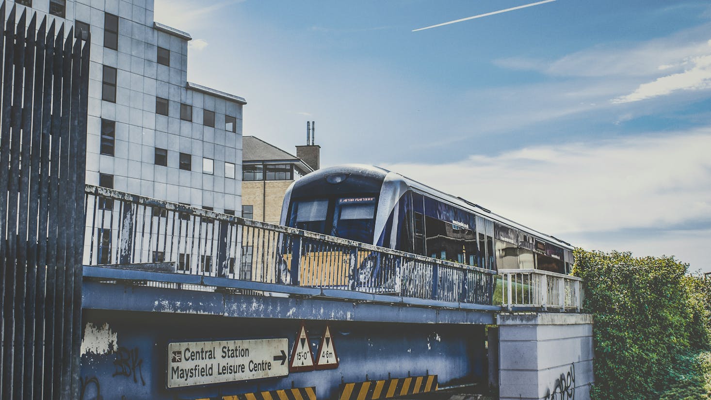 Modern train crossing an elevated bridge near Belfast Central Station and Maysfield Leisure Centre