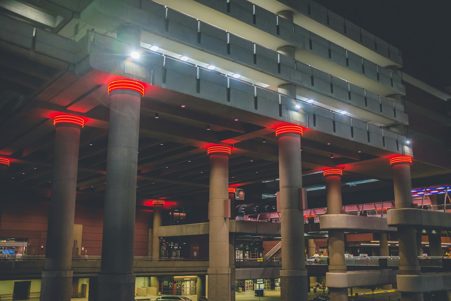 McCarran International Airport (LAS) at night, featuring illuminated concrete pillars with red lights