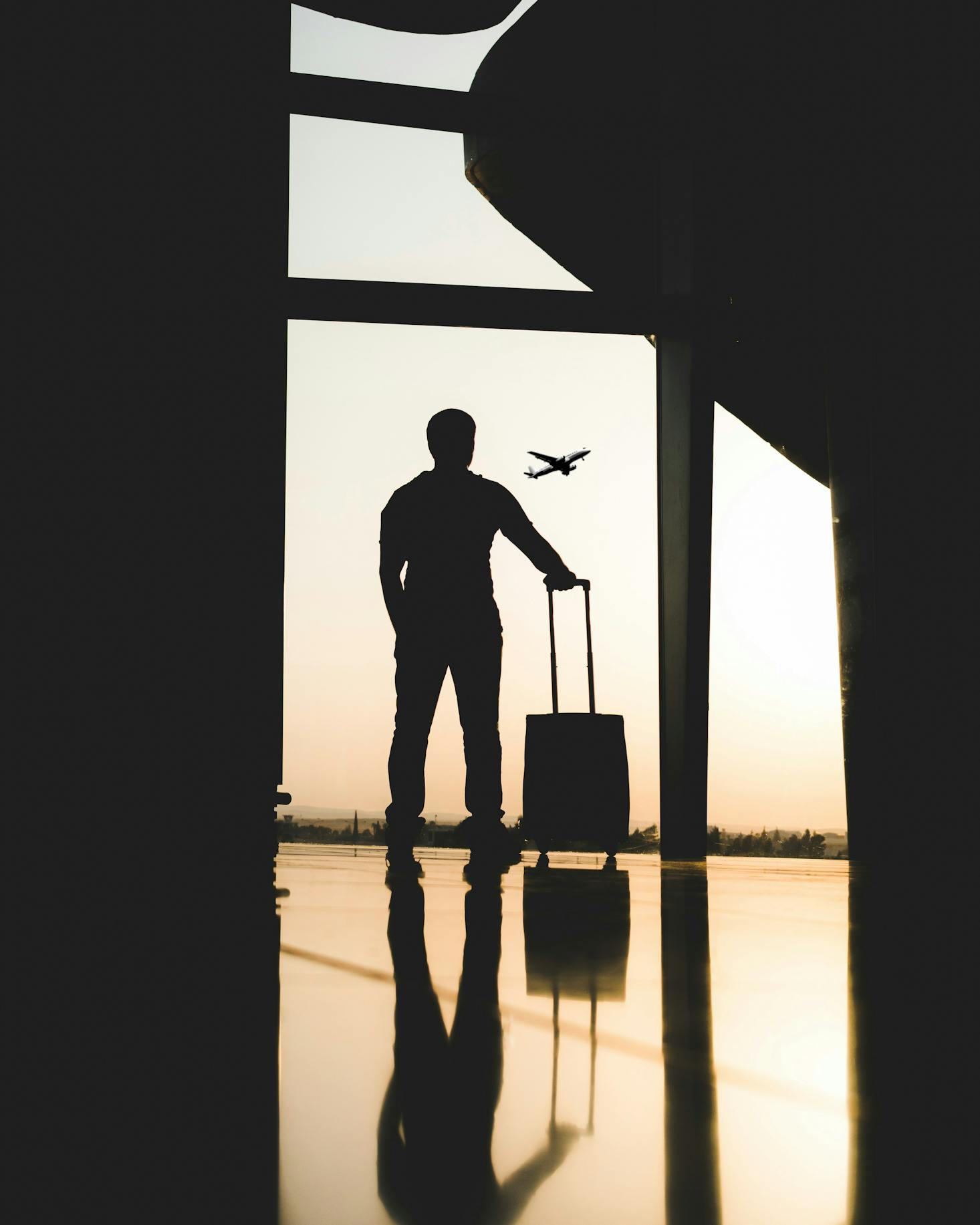 A man gazing outside while waiting inside the Charlotte Airport.