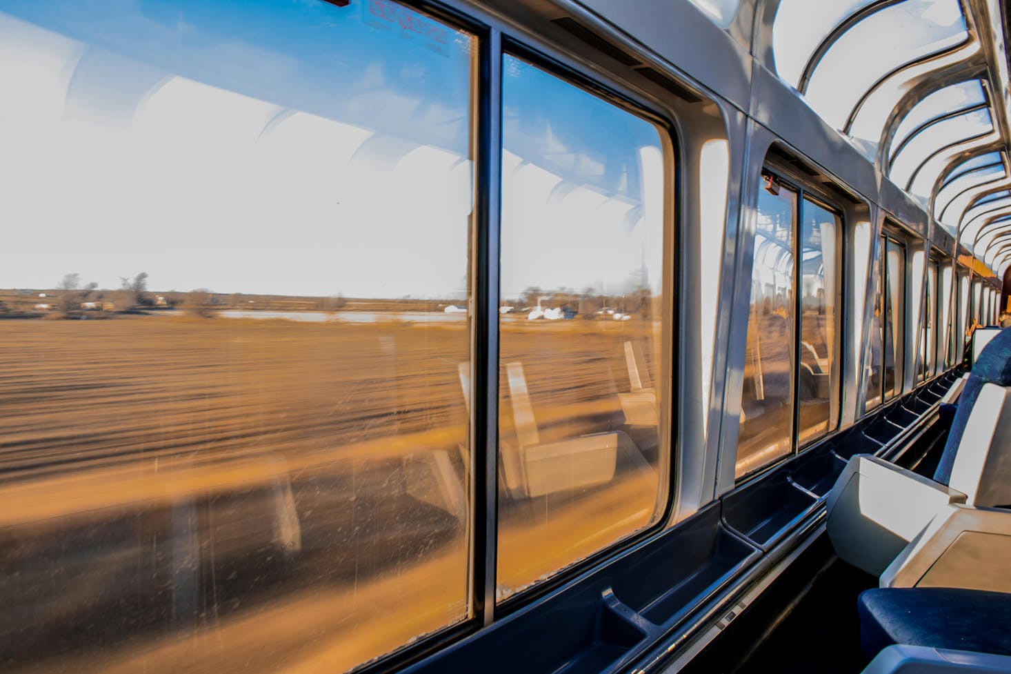 A scenic view from inside a train with large windows from Cordoba Station.