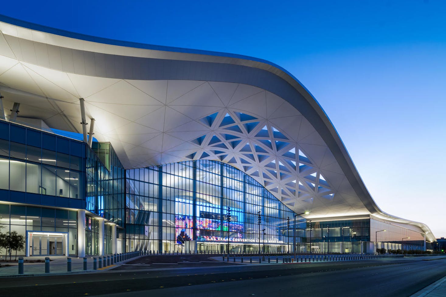 The modern, sleek exterior of the Las Vegas Convention Center with its distinctive curved roof