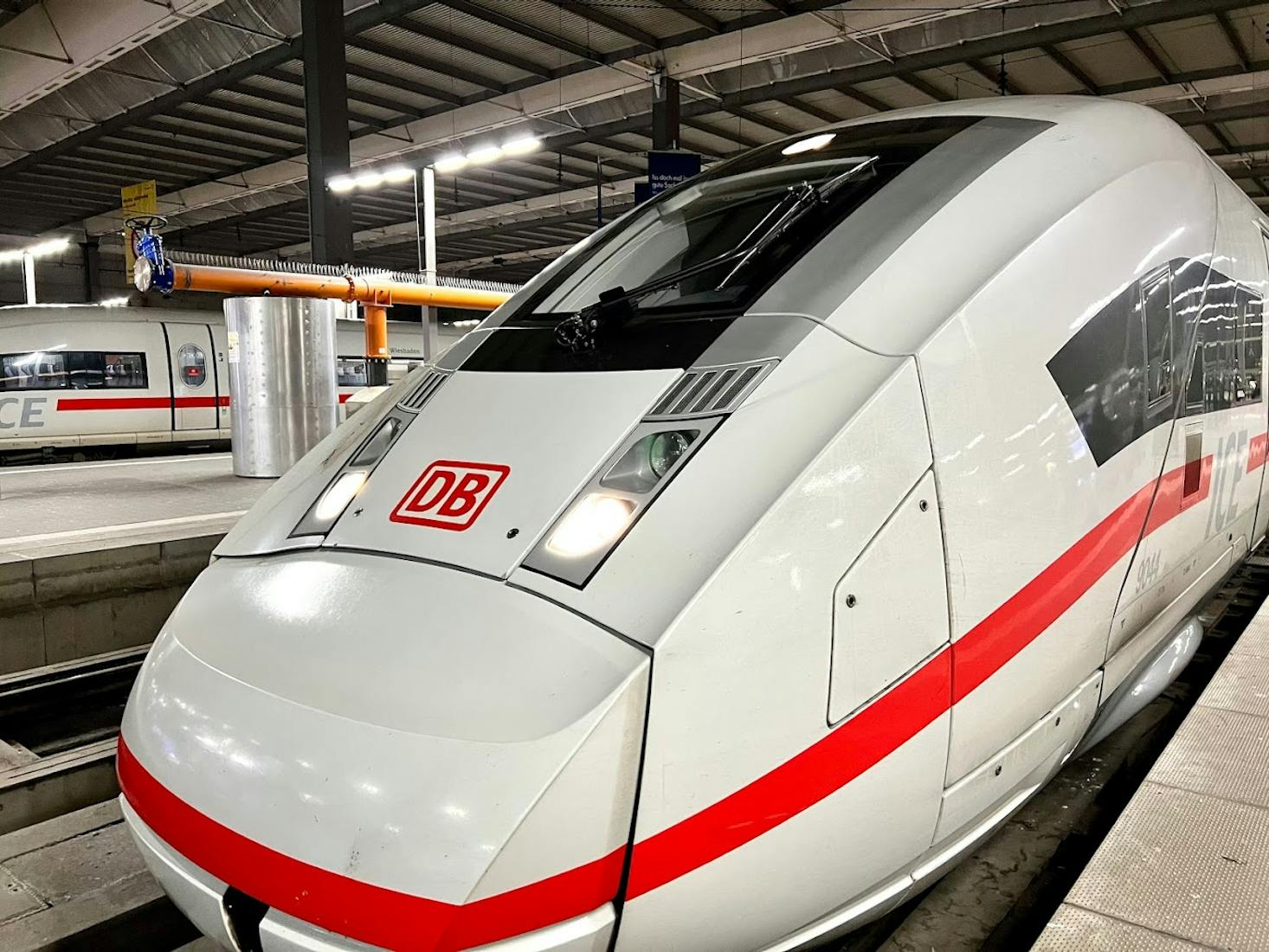 Modern Deutsche Bahn (DB) high-speed train parked at a platform inside the München Hauptbahnhof