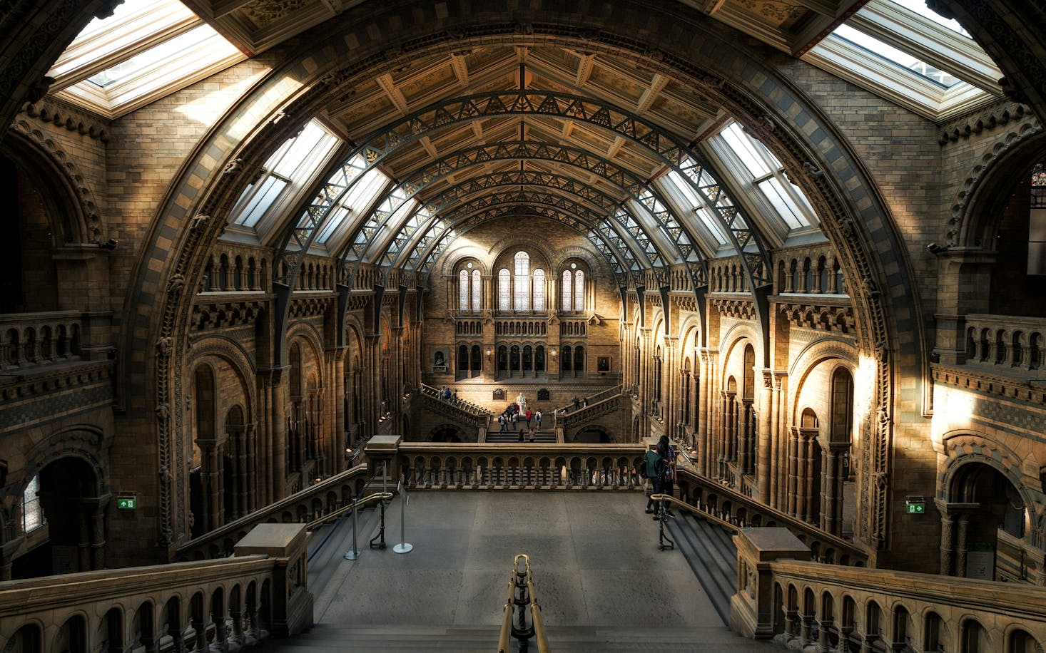 The photo shows the grand interior of the Natural History Museum.