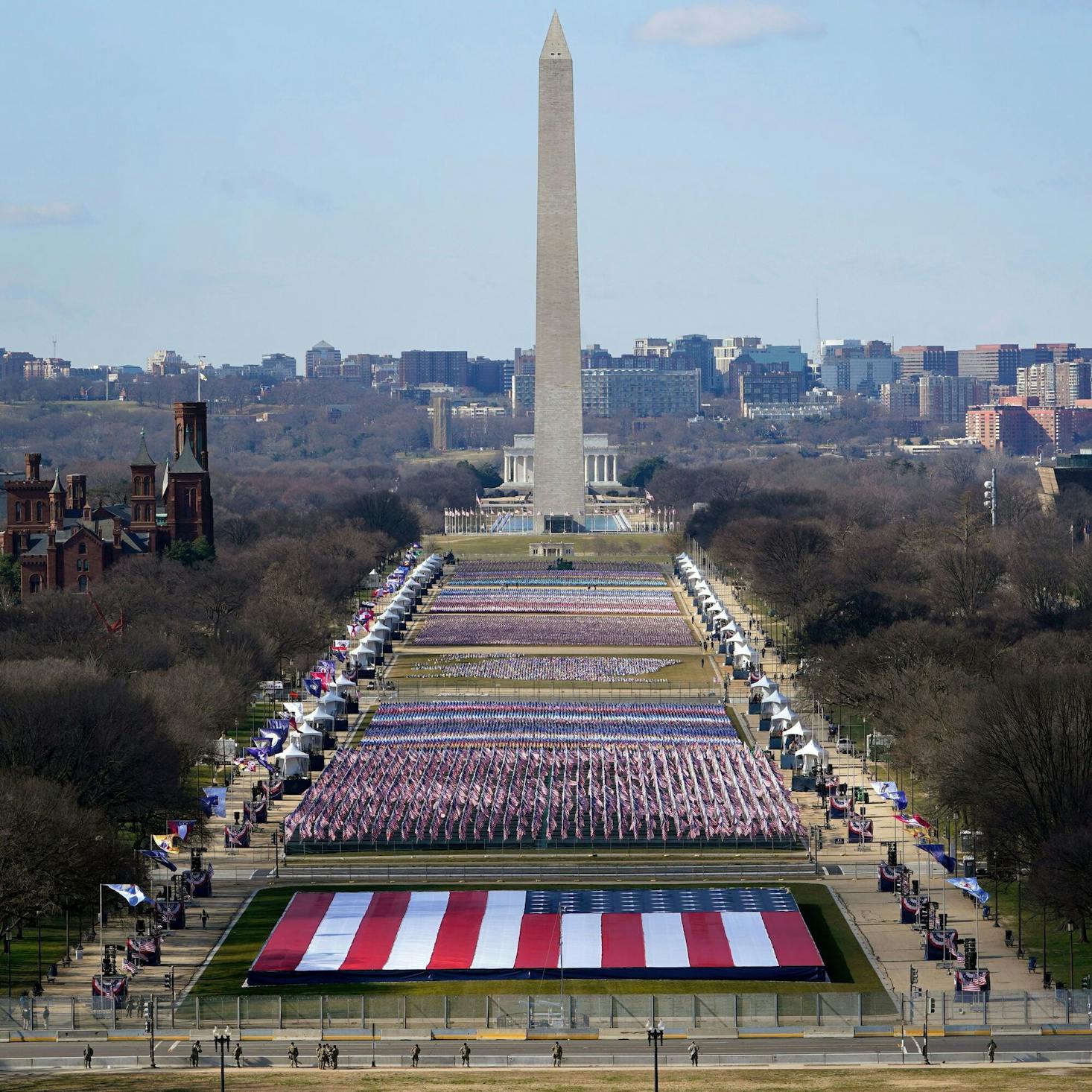 The National Mall in Washington, D.C., featuring the Washington Monument and a large display of American flags arranged in front of it.