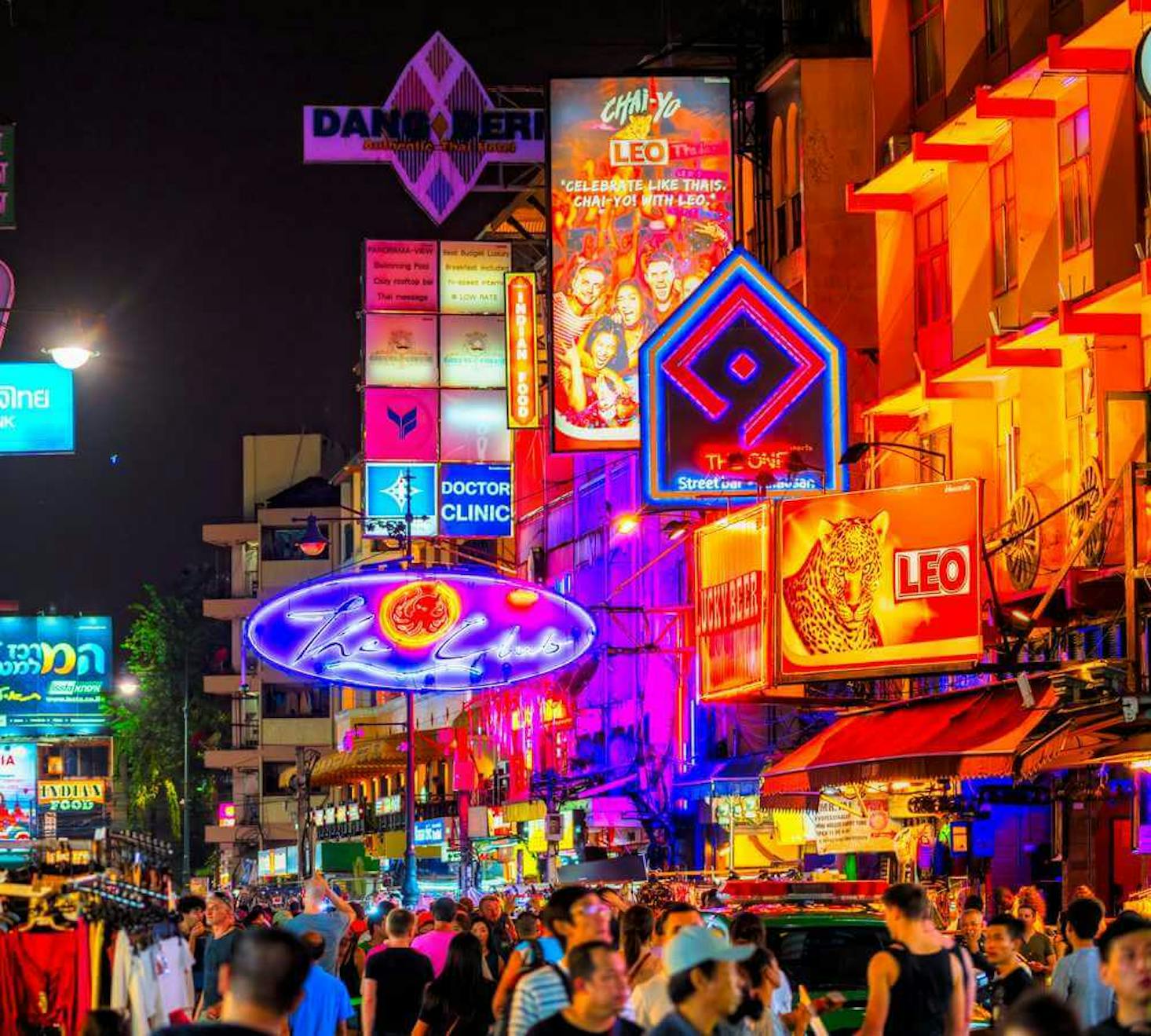 The vibrant and bustling Khao San Road in Bangkok at night.