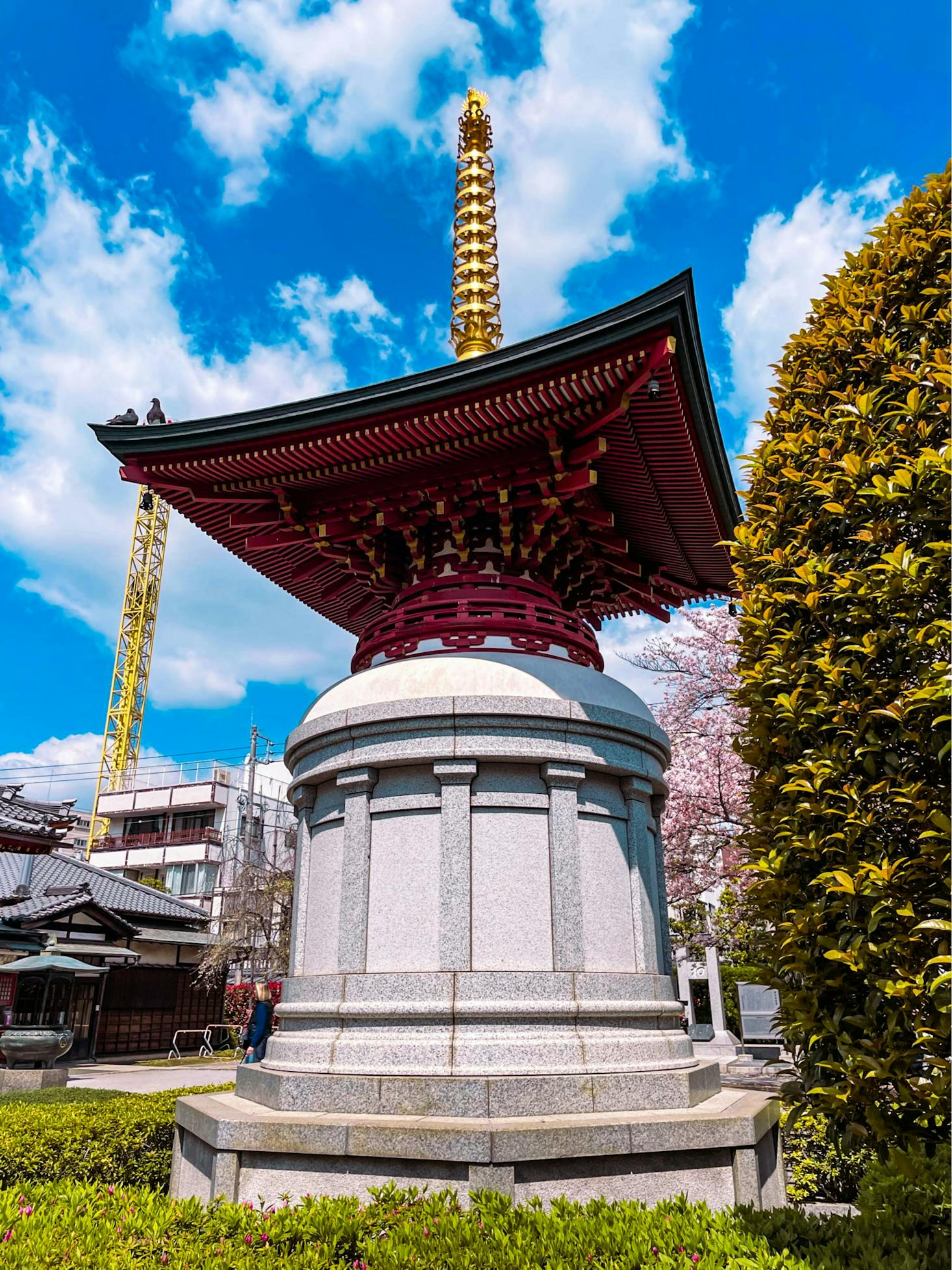 A traditional Japanese pagoda structure with a golden spire in Asakusa, Tokyo