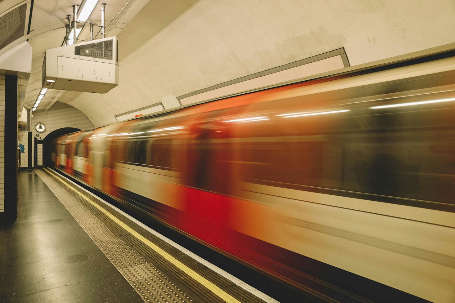 Train speeds through Holborn station, capturing the dynamic energy and motion of the city.