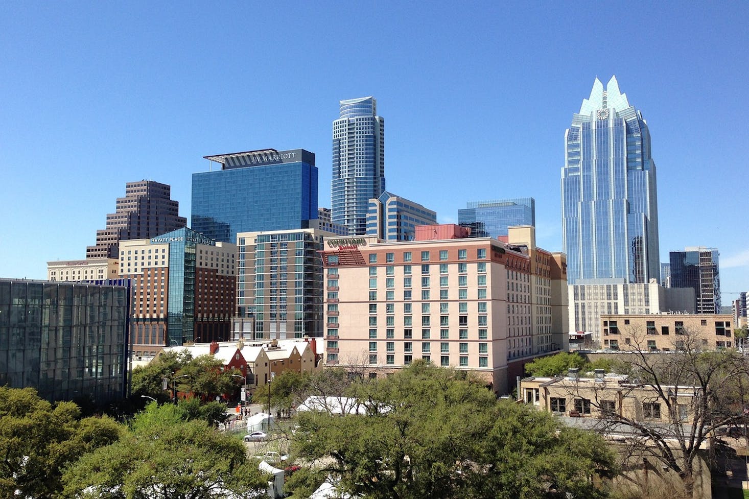 A cityscape of Austin with modern high-rise buildings near the Austin Visitor Center