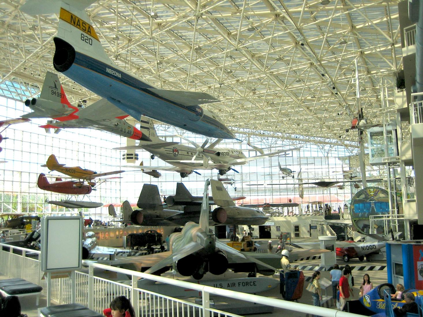 The interior of the Museum of Flight, featuring numerous aircraft suspended from the ceiling