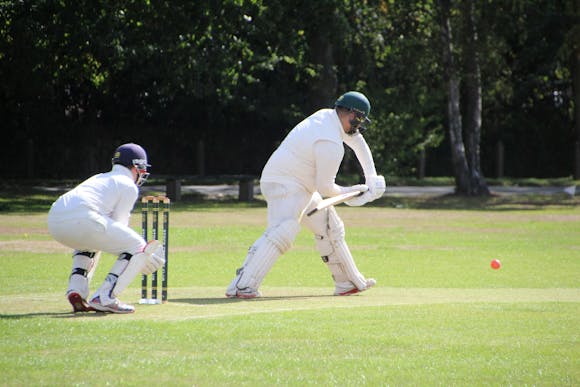 Cricketers on a field in action during a match