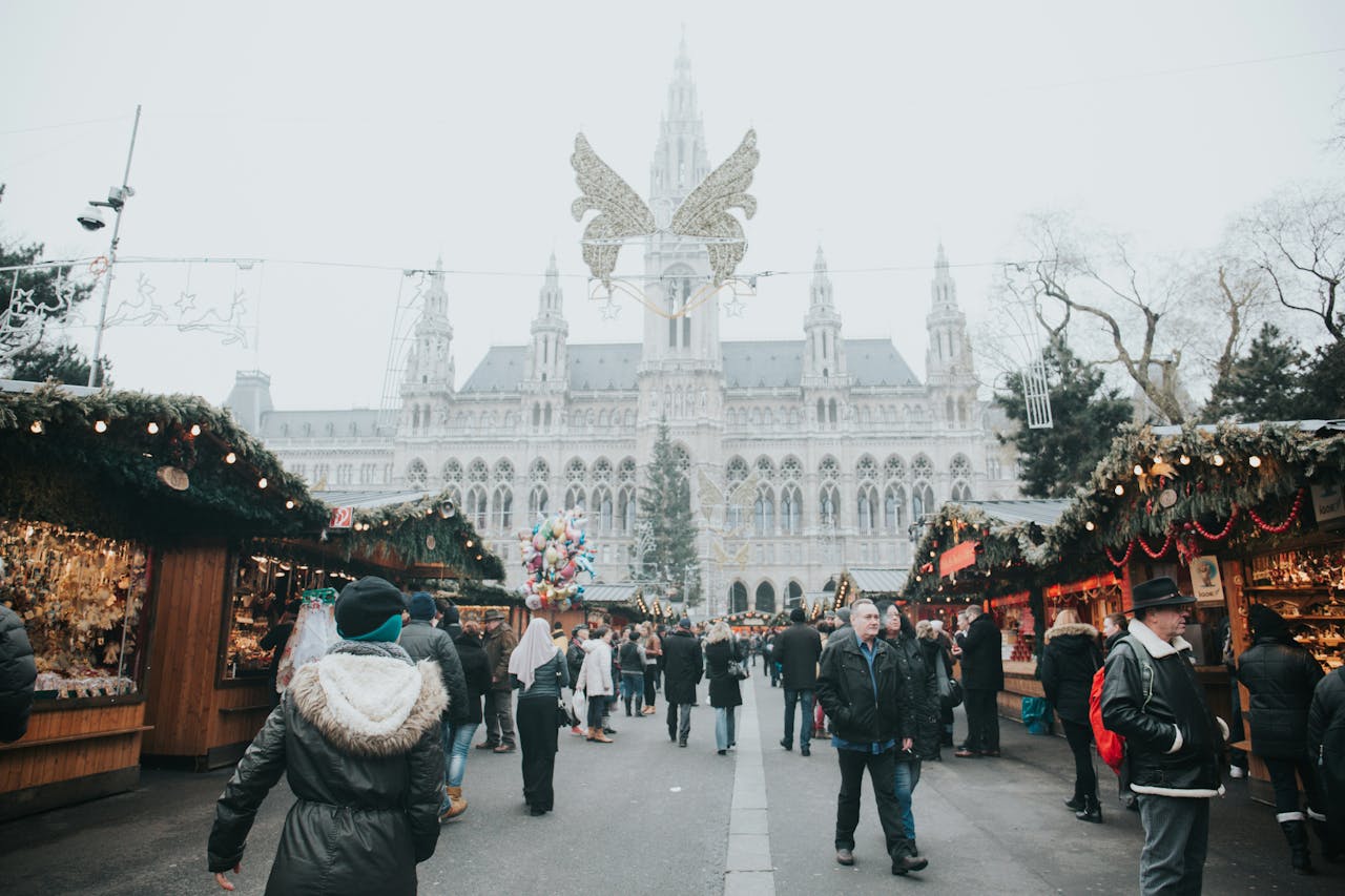 Snow-covered and decorated street packed with shoppers enjoying the vibrant atmosphere of a Christmas market