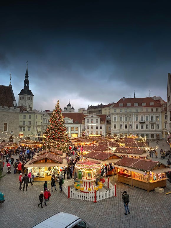 Beautifully decorated stalls at a Christmas market in a bustling city