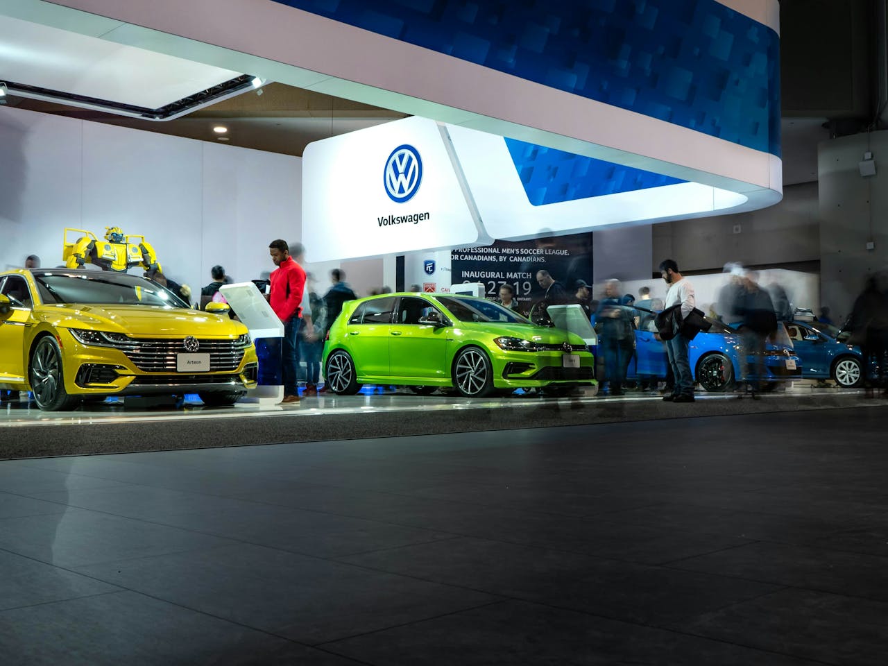 Crowd admiring a range of modern Volkswagen cars