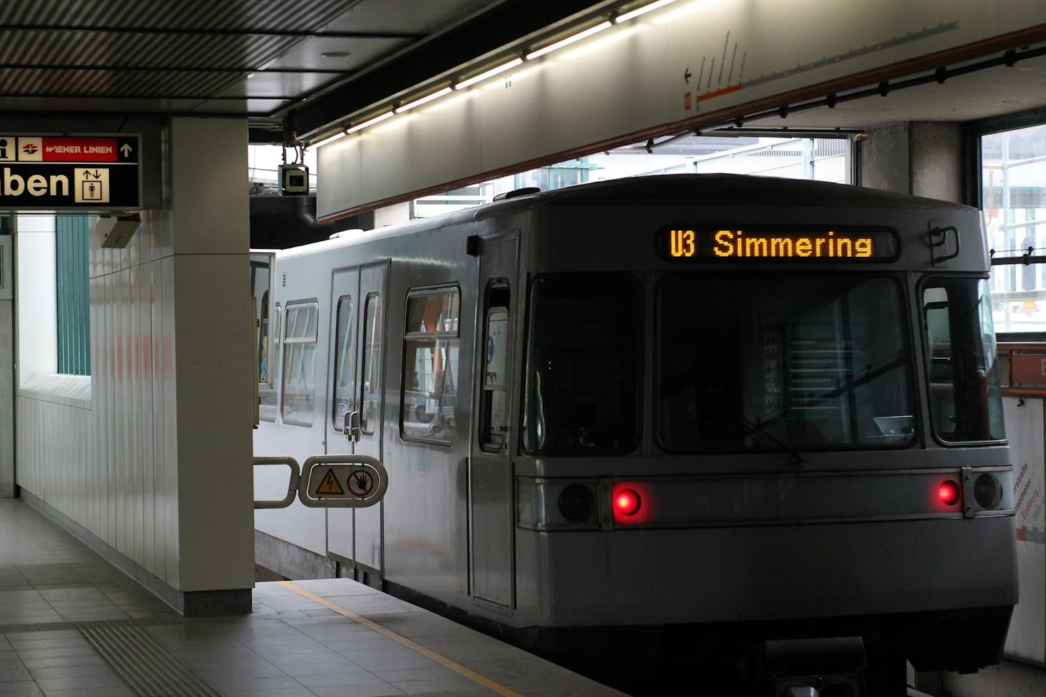 Train pulling into a modern looking subway station in Vienna, Austria