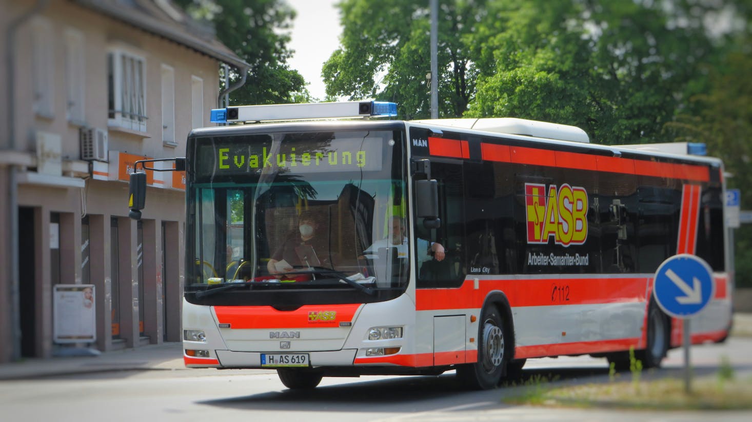 An orange and white bus heading to ZOB Hannover Central Bus Station