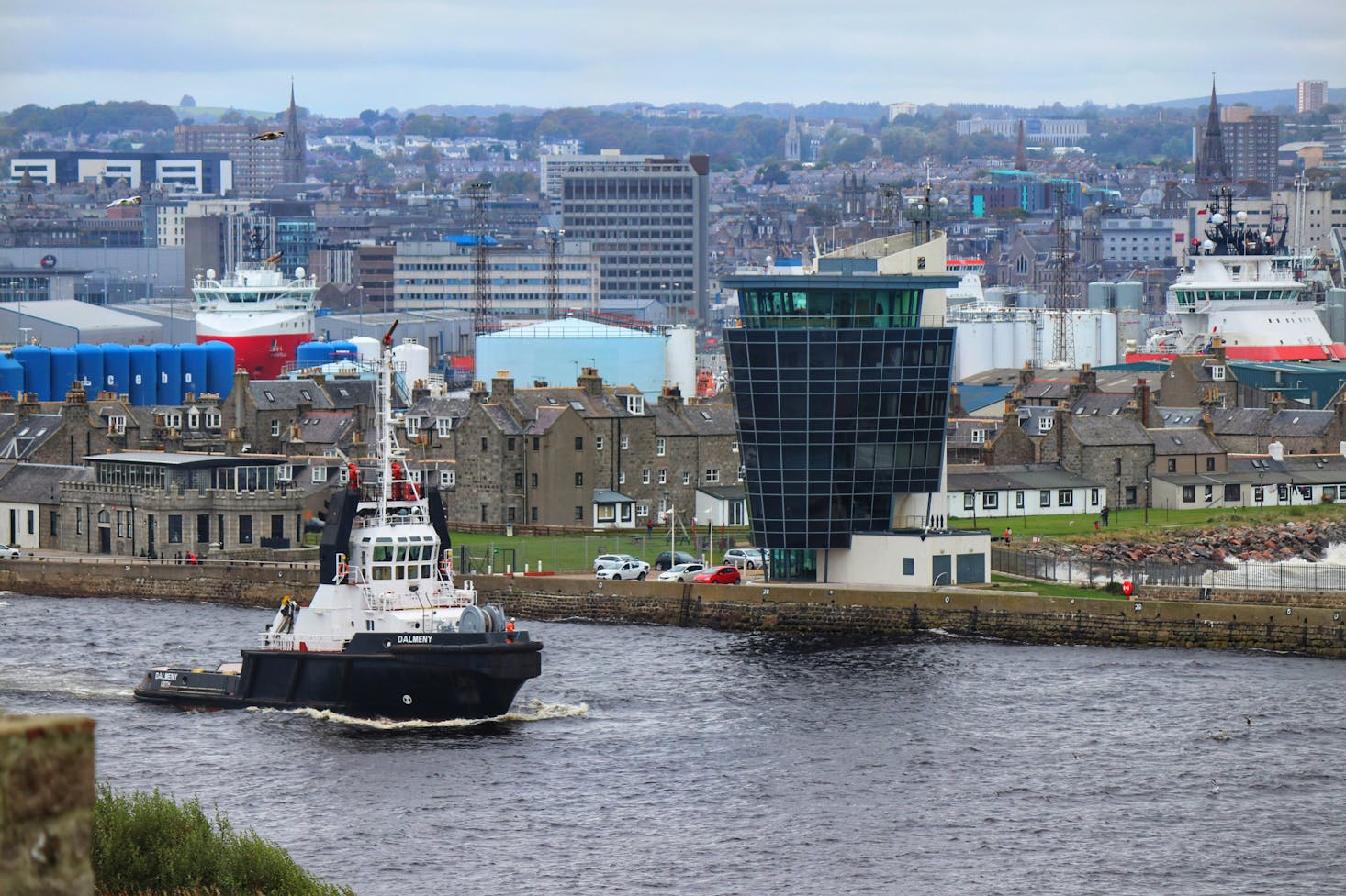 Tugboat traveling down the river in Aberdeen, Scotland