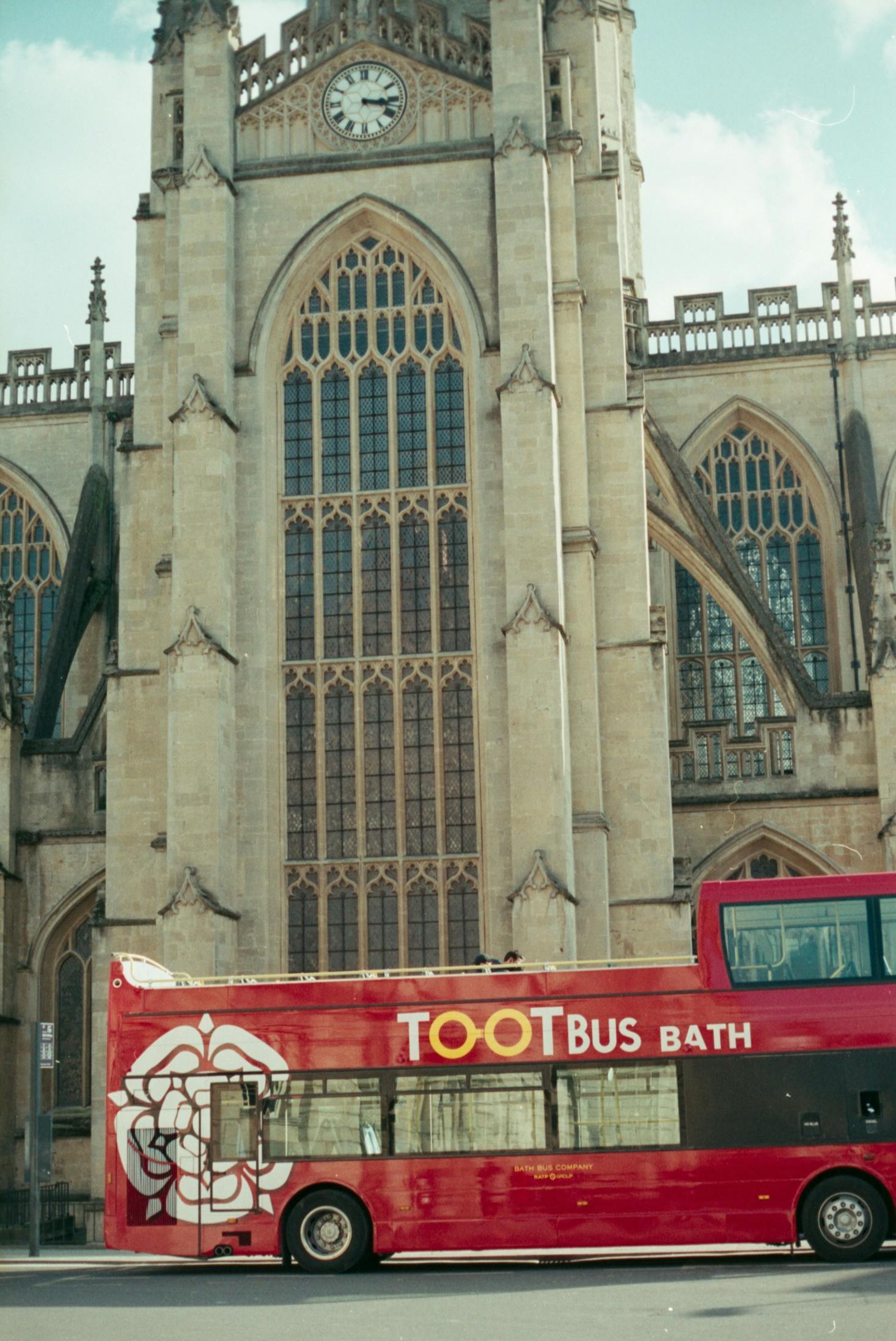 Bus passing by Bath Cathedral near Bath Bus Station