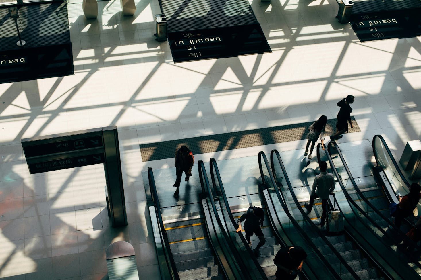 People walking off escalators at Hong Kong Station, Hong Kong