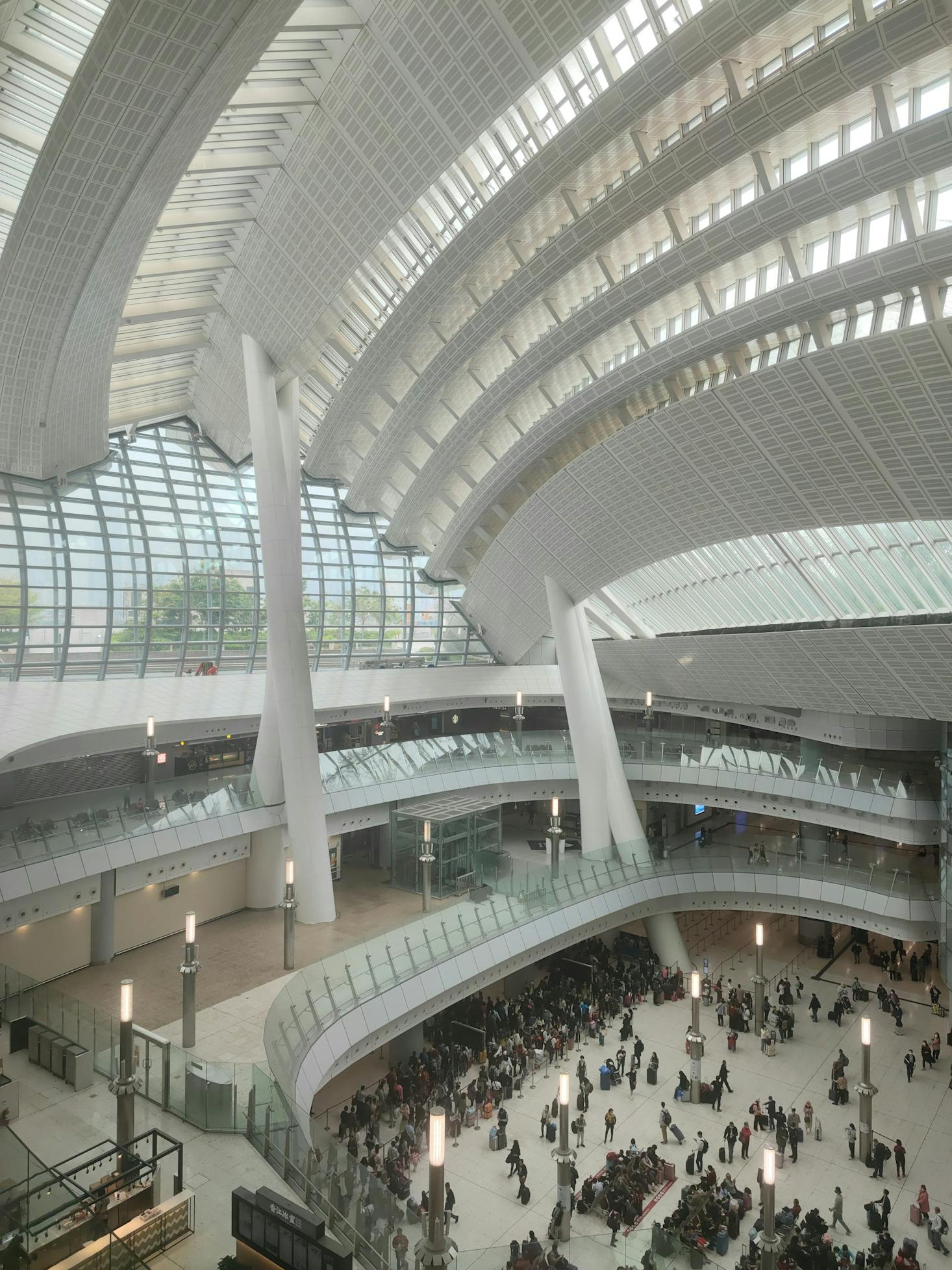 The arrivals hall is filled with people in West Kowloon Station in Hong Kong, China