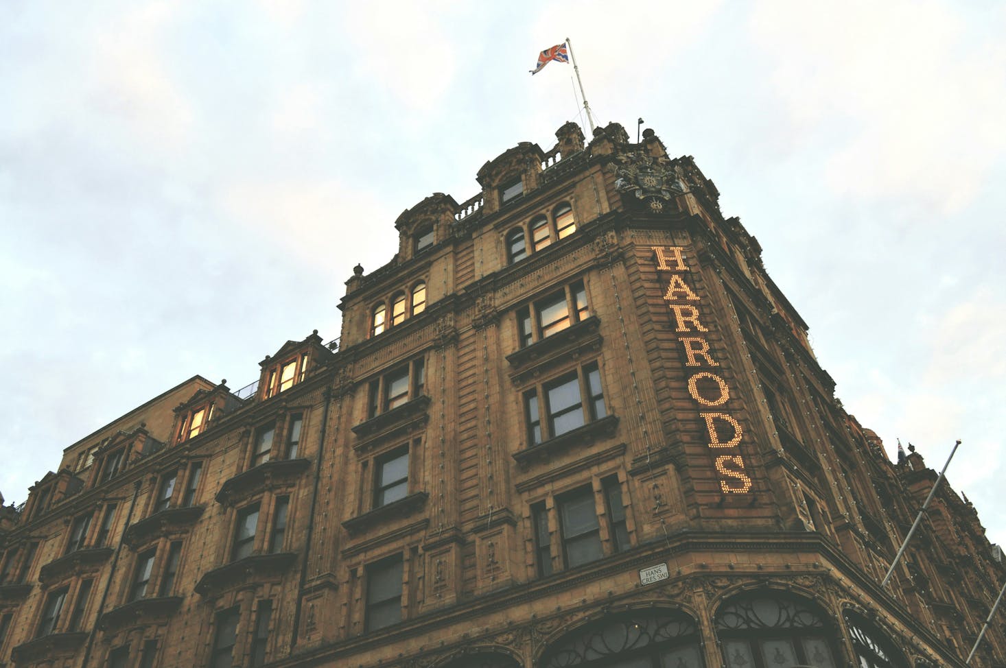 Facade of the Harrods brown brick building in London's Knightsbridge neighborhood