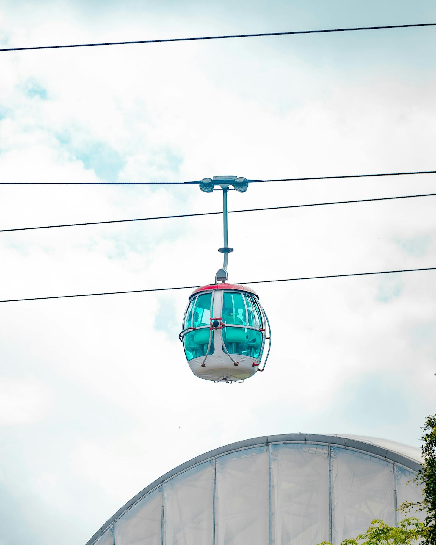 A cable car going over Ocean Park in Hong Kong on a cloudy day