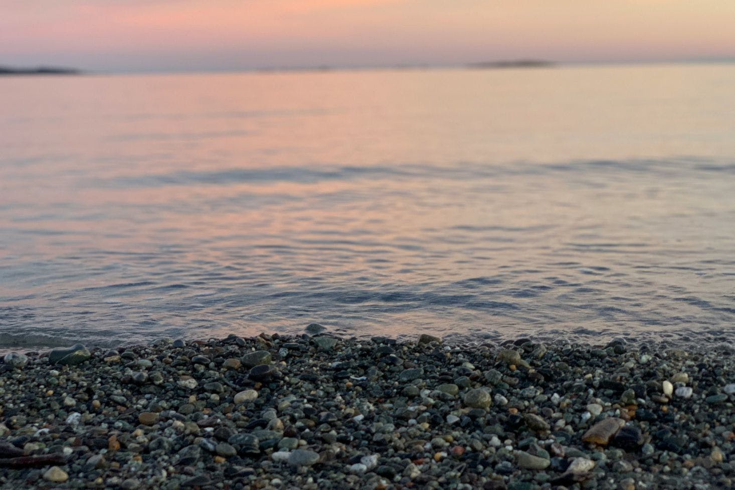 Pebbly Willows Beach in Victoria with a view of the horizon during a pink sunset 