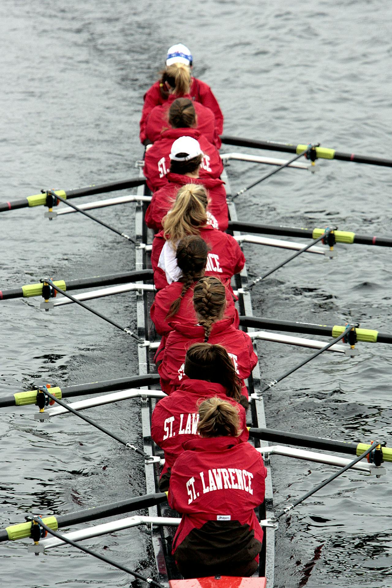 Group of rowers in a boat competing at the Head of the Charles Regatta, showcasing teamwork and athleticism