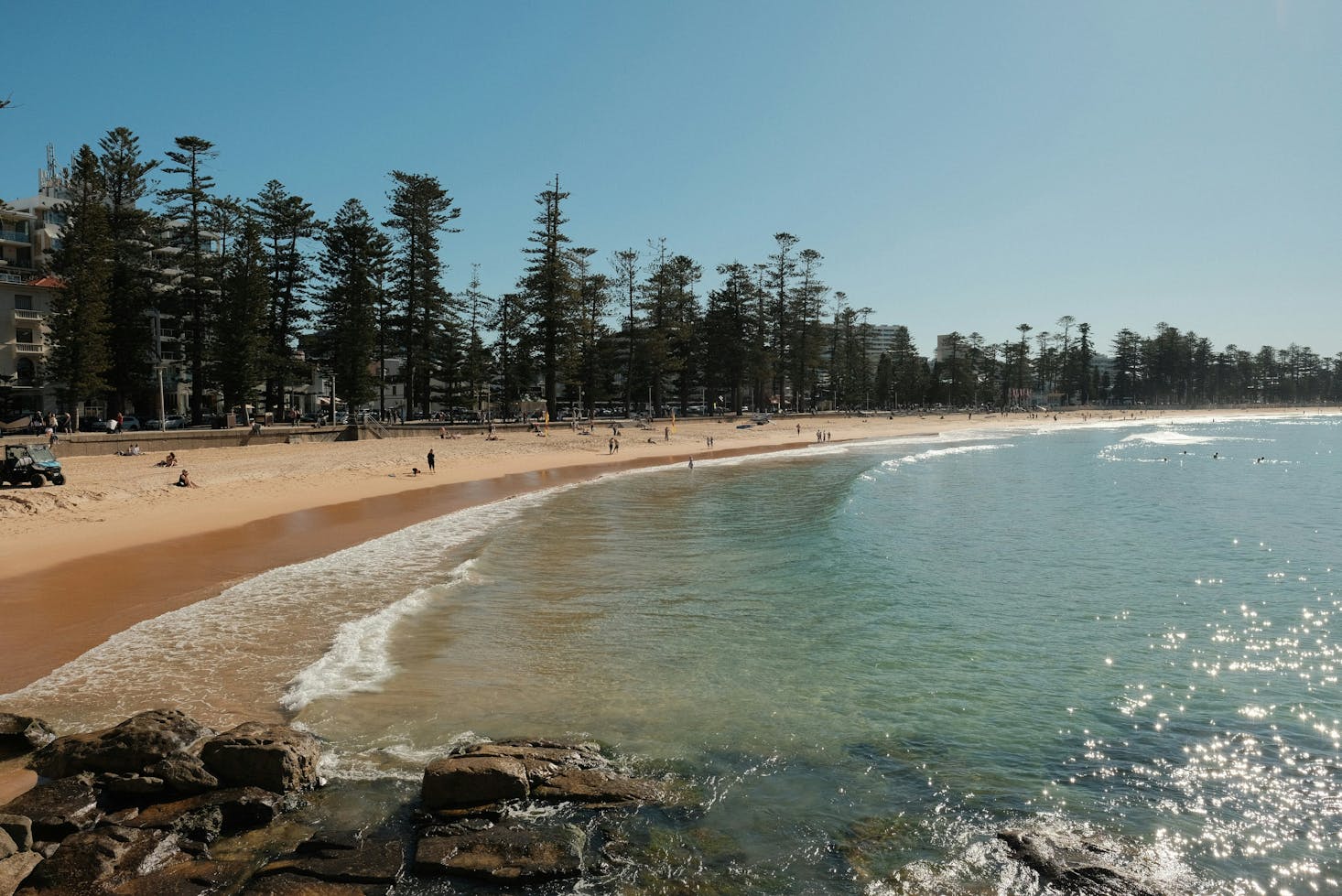 Calm waves on golden sand at Manly Beach near Sydney