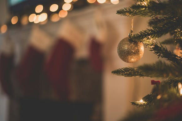 Christmas tree decoration with bright lights and Christmas stockings in the background