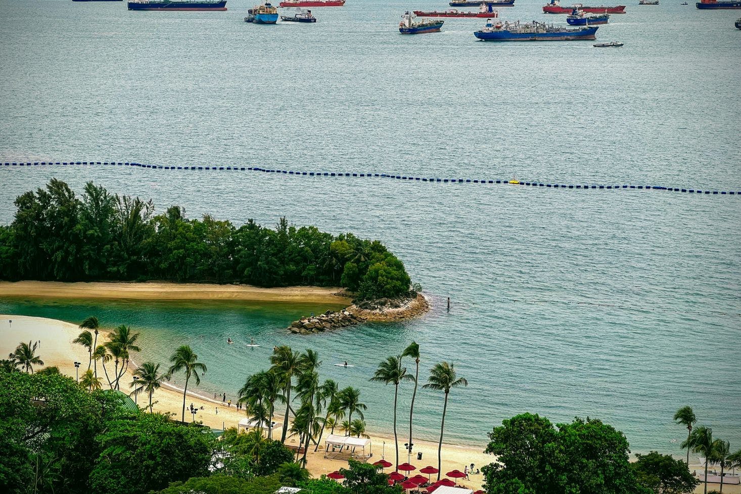 Southern Island sandy beaches near Singapore with palm trees and greenery overlooking the sea