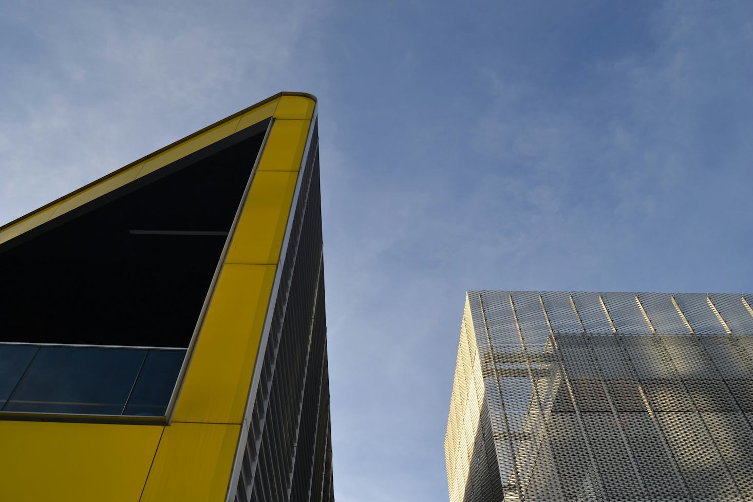 The modern exterior of ExCeL London with natural metals and yellow panels